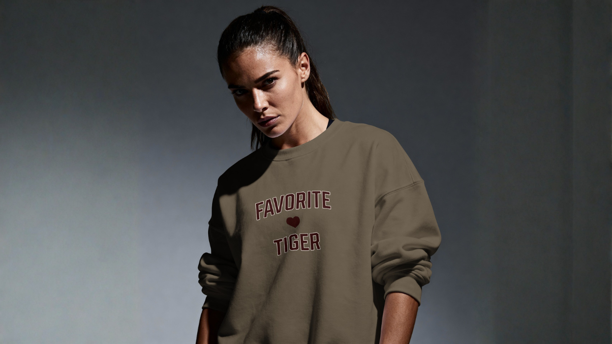 Woman in oversized streetwear sweatshirt with 'Favorite Tiger' text and heart design