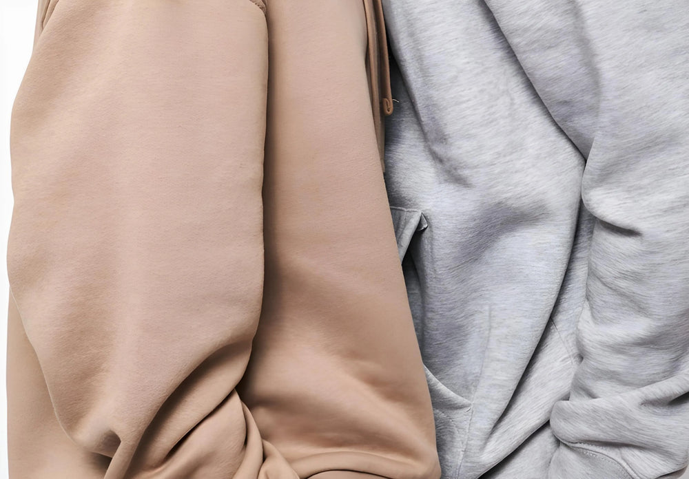 Beige and grey oversized streetwear sweats with soft fabric texture close-up